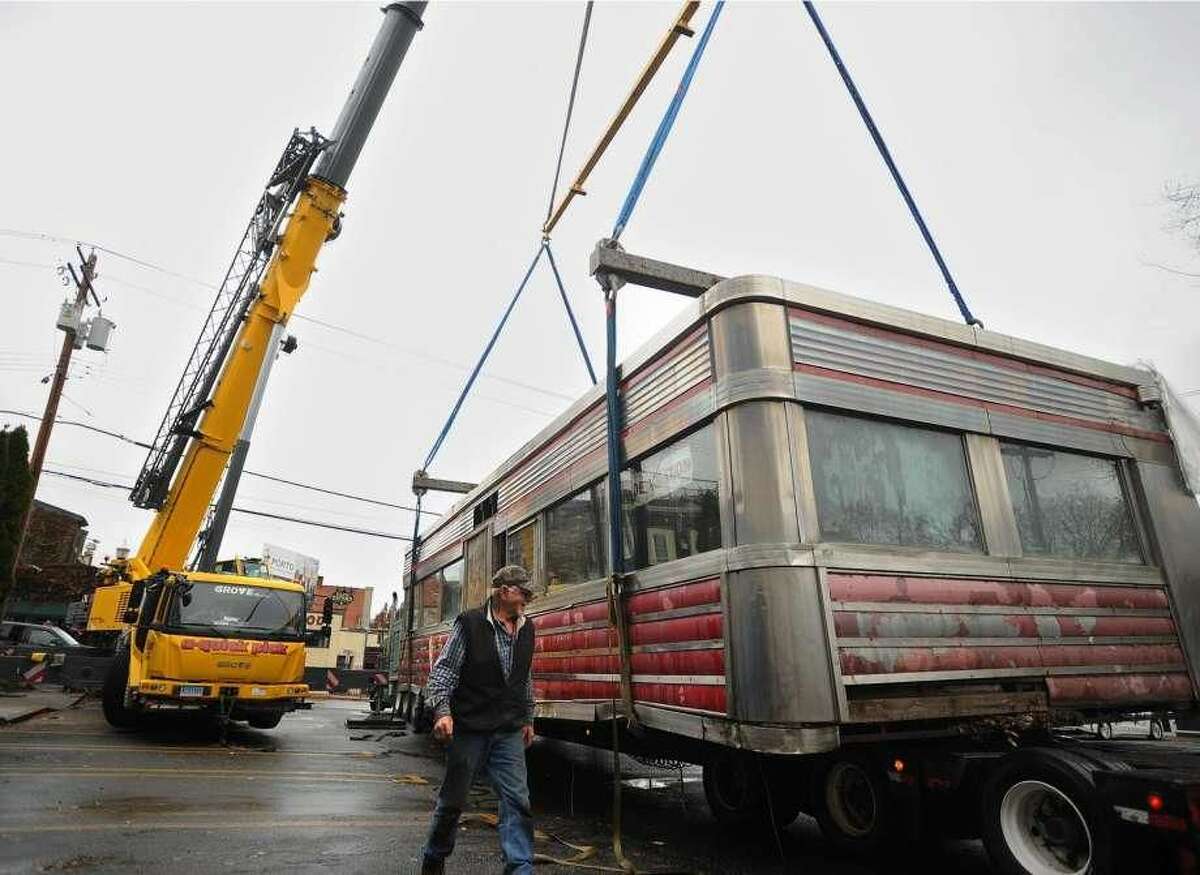 The Milford Diner is loaded on to a flatbed truck for transport from its location on New Haven Avenue in downtown Milford on Tuesday. The 1946 diner is travelling to Kokomo, Indiana, where it will be restored and reopen for business.