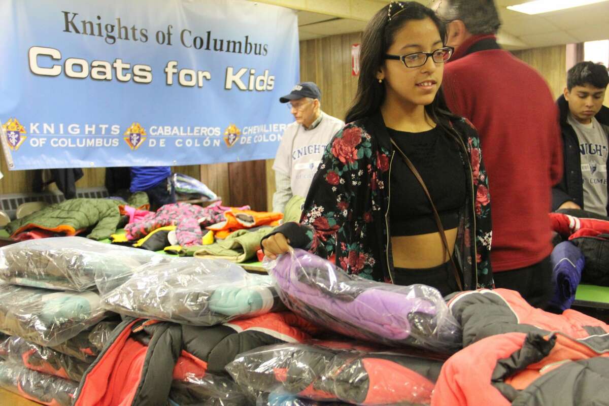 Children receive free coats from the Knights of Columbu Coats for Kids drive on Friday, Nov. 24, 2017 at St. John the Baptist Church in New Haven. Organizers said 300 coats were available for children.