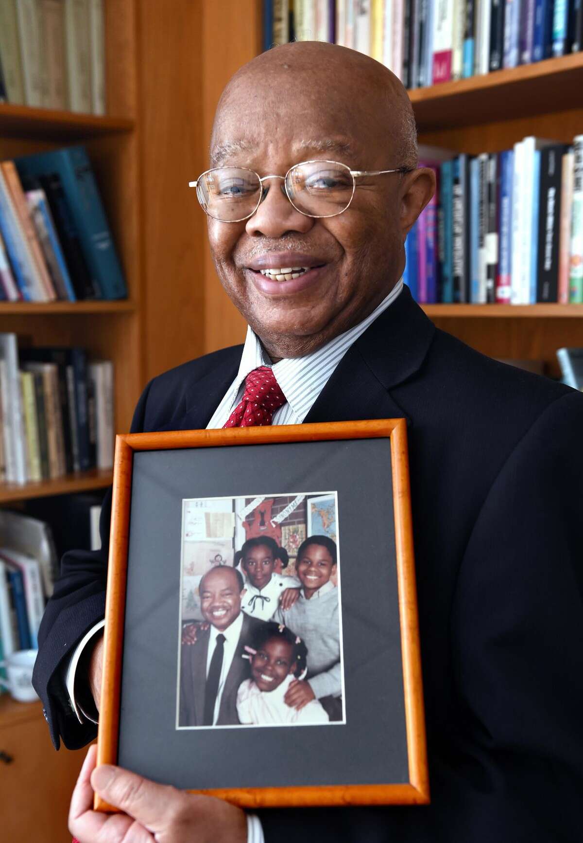 Dr. James Comer of the Yale Child Study Center is photographed on Oct. 29 holding an old picture taken with students at the former Martin Luther King Jr. Elementary School in New Haven.