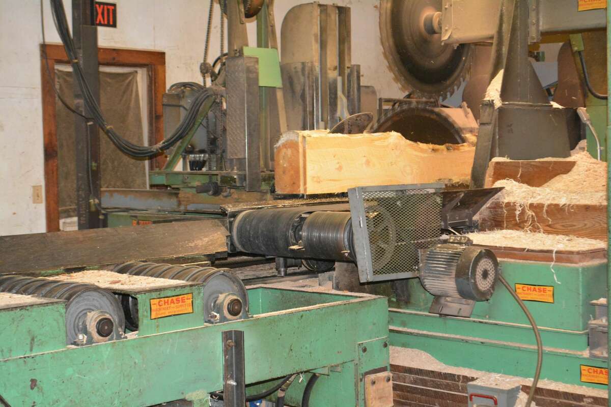 A log is sawn into boards in a process that is described as cutting the wood "just like a deli slicer."