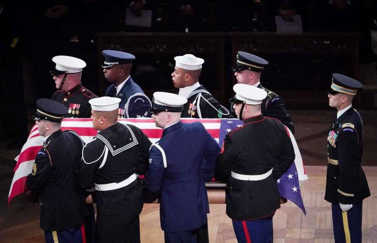 Allon C. Louisgene, a U.S. Navy sailor from Milford, was part of the military honor guard that carried the flag-draped casket of former President George H.W. Bush out after the State Funeral at the National Cathedral, Wednesday, Dec. 5, in Washington. Louisgene is the third member in the top row wearing the sailor's cap.