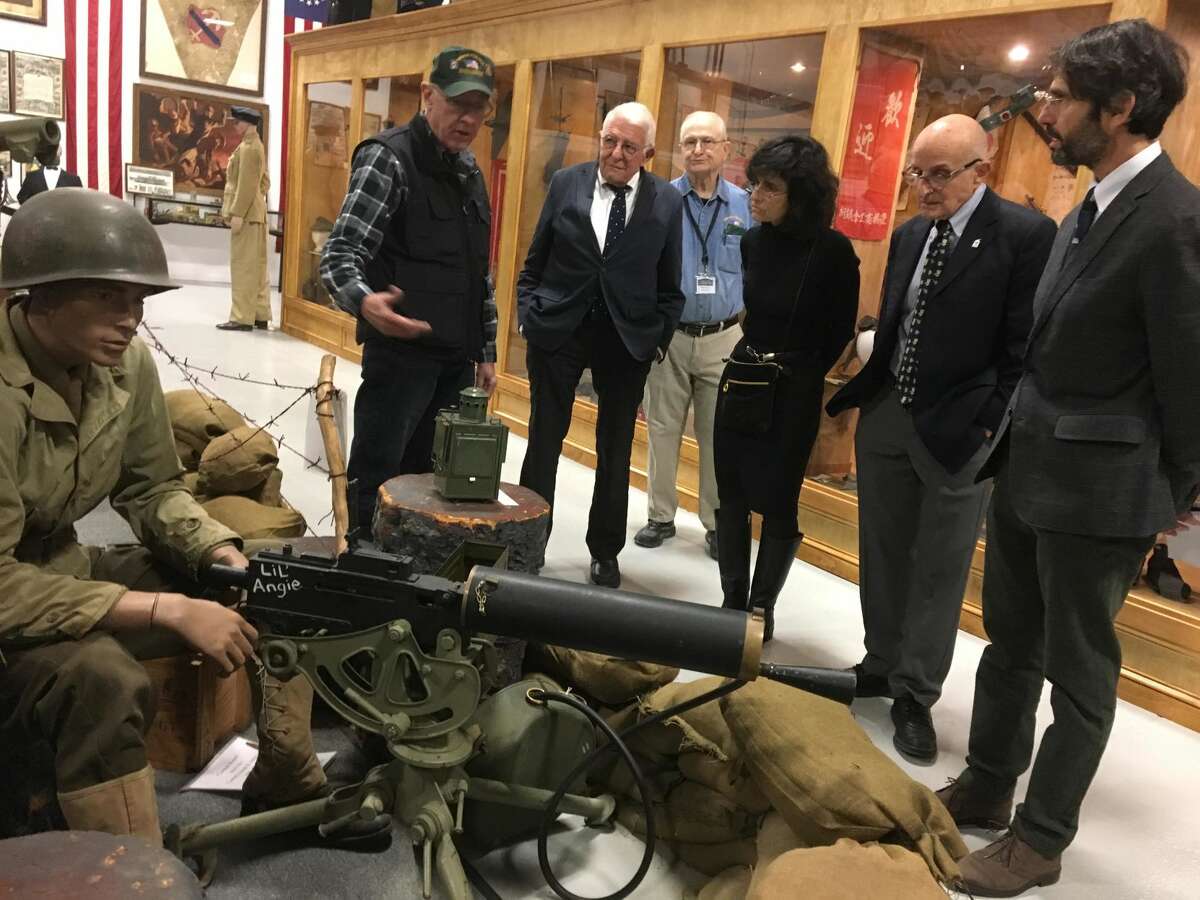 West Haven Military Museum volunteer Bill Benson, a Vietnam veteran, shows family members of the late Edward N. Silver around the museum after a "wall-breaking" ceremony for the new Edward N. Silver Media Center at the West Haven Veterans Museum and Learning Center. With him are, from left, Dr. Bob Silver, museum President Frank Chasney, Wendy Silver, David Silver and Richard Silver. The media center is being built with a donation of nearly $60,000 from the West Haven Rotary Foundation. It will include a library and a conference room along with computer access.