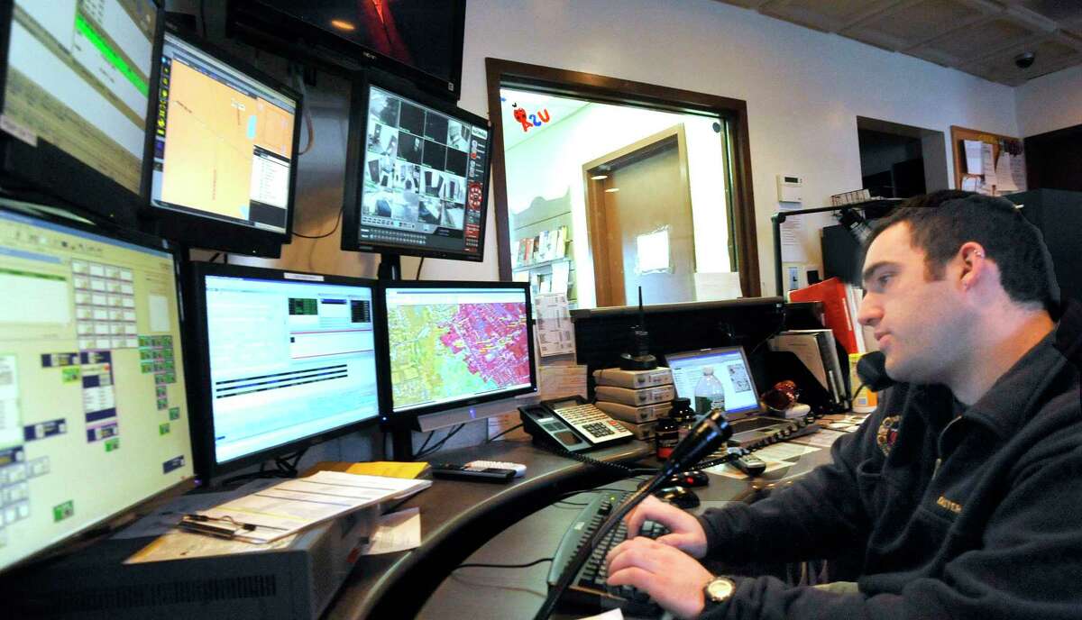 Newtown police dispatcher, Michael Easty, answers a call for service at Newtown police headquarters Monday, Feb. 14, 2011.