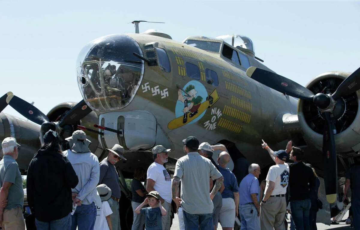 In this photo taken June 2, 2018 photo, people look over the Nine-O-Nine, a Collings Foundation B-17 Flying Fortress, at McClellan Airport in Sacramento, Calif.
