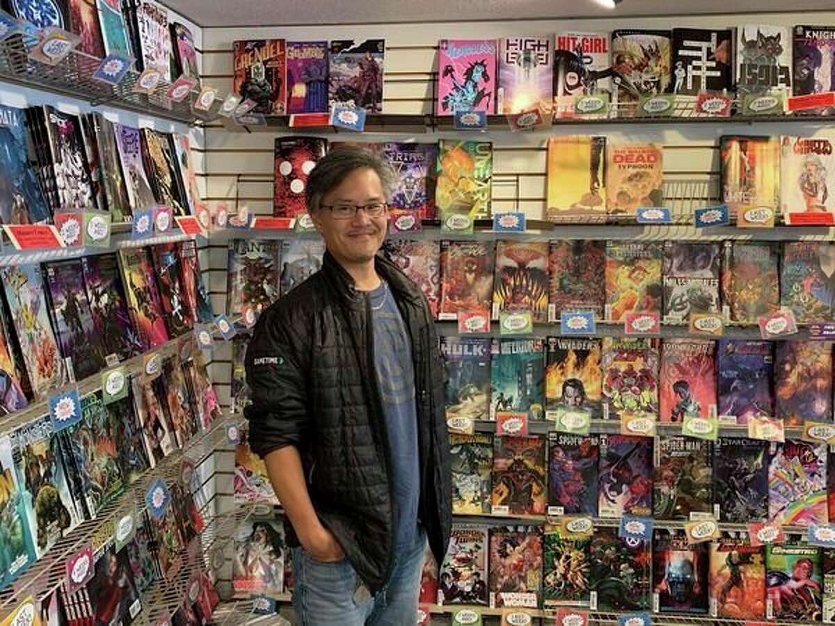 Andrew Iwamasa, owner of the Collectors Corner comic book store, poses for a photo at the shop's 4011 North Jefferson Ave. location. (Mitchell Kukulka/Mitchell.Kukulka@mdn.net)