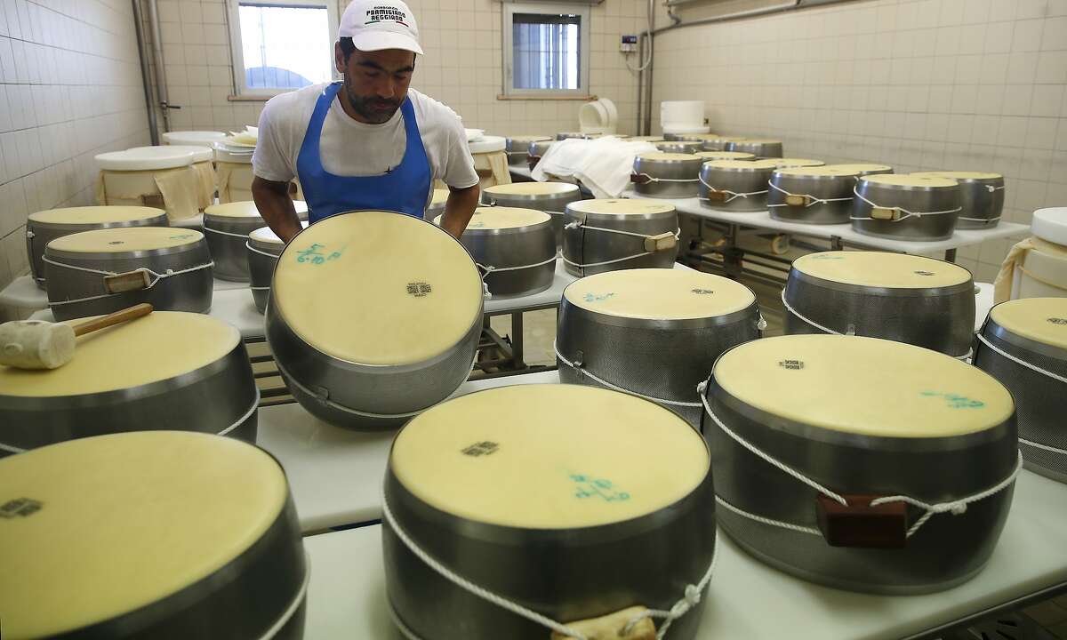 In this photo taken Tuesday, Oct. 8, 2019, Parmigiano Reggiano Parmesan cheese wheels are created in Noceto, near Parma, Italy. U.S. consumers are snapping up Italian Parmesan cheese ahead of an increase in tariffs to take effect next week. The agricultural lobby Coldiretti on Friday, Oct. 11, 2019, said sales of both Parmigiano Reggiano and Grana Padano, aged cheeses defined by their territory of origin, have skyrocketed by 220% since the higher tariffs were announced one week ago. (AP Photo/Antonio Calanni)