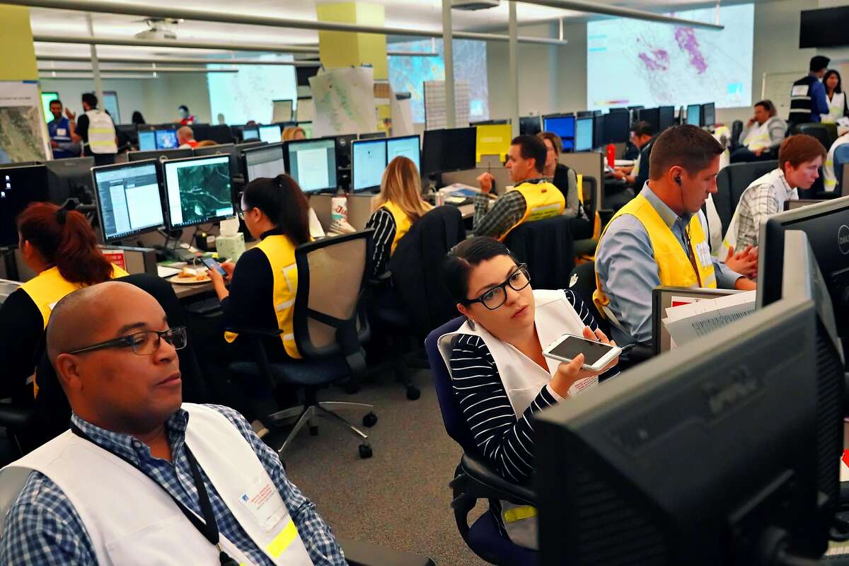 PG&E employees working at the emergency operations center where public safety shutoff was confirmed for nearly 800,000 customers in Calif. on Tuesday, Oct. 8, 2019 in San Francisco, Calif.