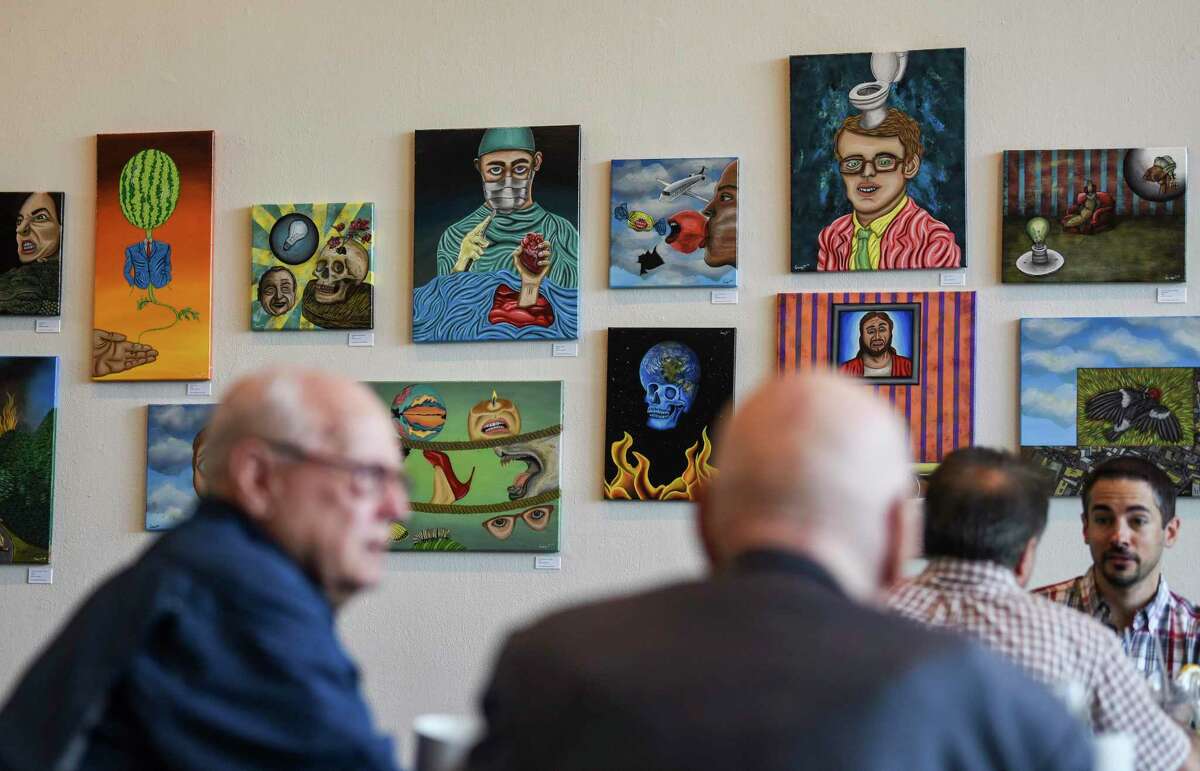 Various art hangs on the walls of the Art Museum of Southeast Texas as people eat lunch at the Sue Mann Weisenfelder Cafe Thursday afternoon. Beaumont's downtown recently was designated a cultural district by the Texas Commission on the Arts Photo taken on Thursday, 09/12/19. Ryan Welch/The Enterprise