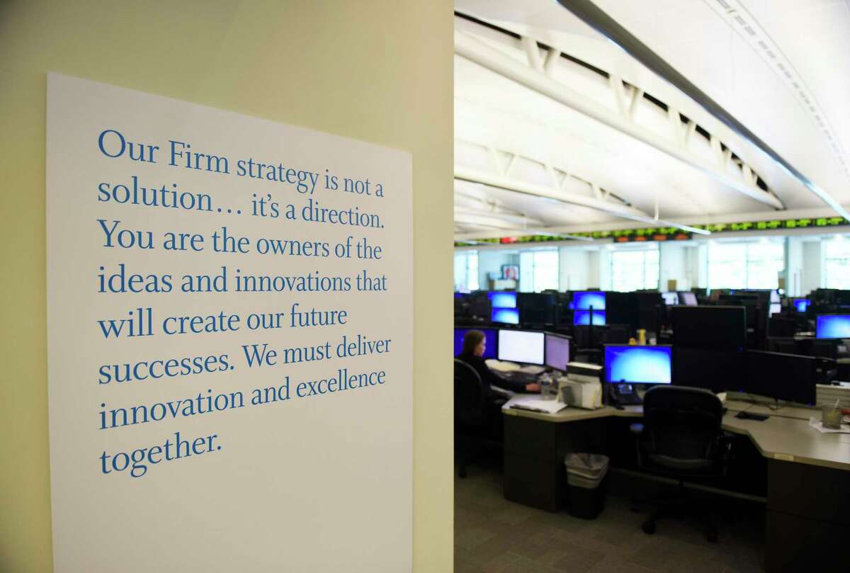 A mission hangs on a wall of the trading floor at Point72 Asset Management's headquarters in Stamford, Conn.