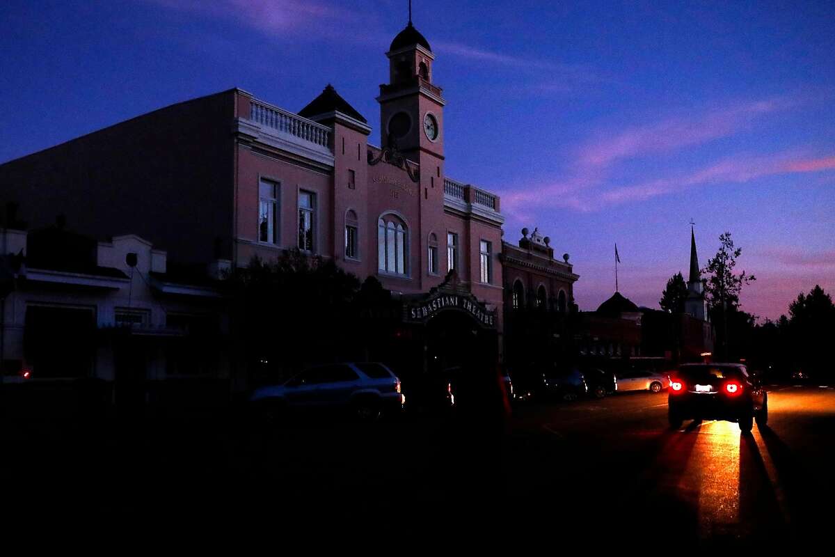 The sun sets on the dark First Street side of the town square during the PG&E power shut-off continues in Sonoma, October 10, 2019.