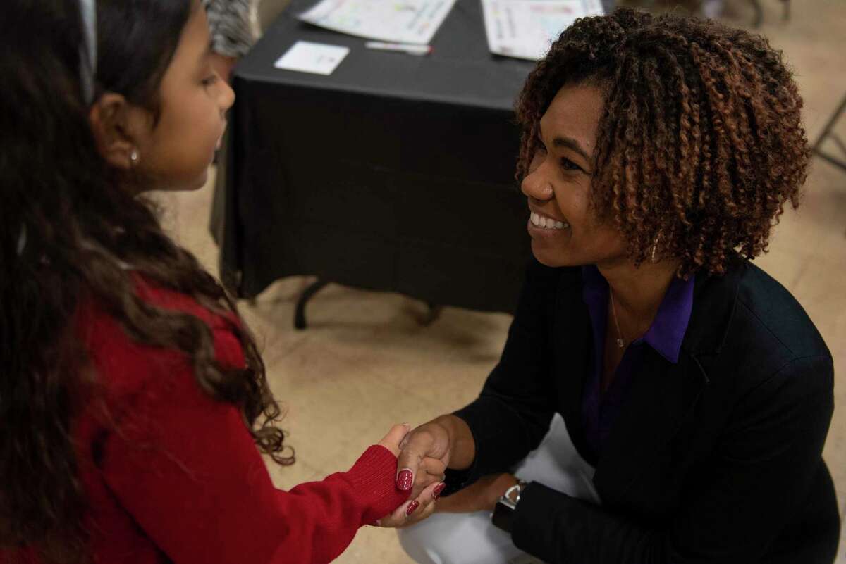 A student speaks with Victoria Washington of local nonprofit Ransomed Life at a celebration of International Day of the Girl.