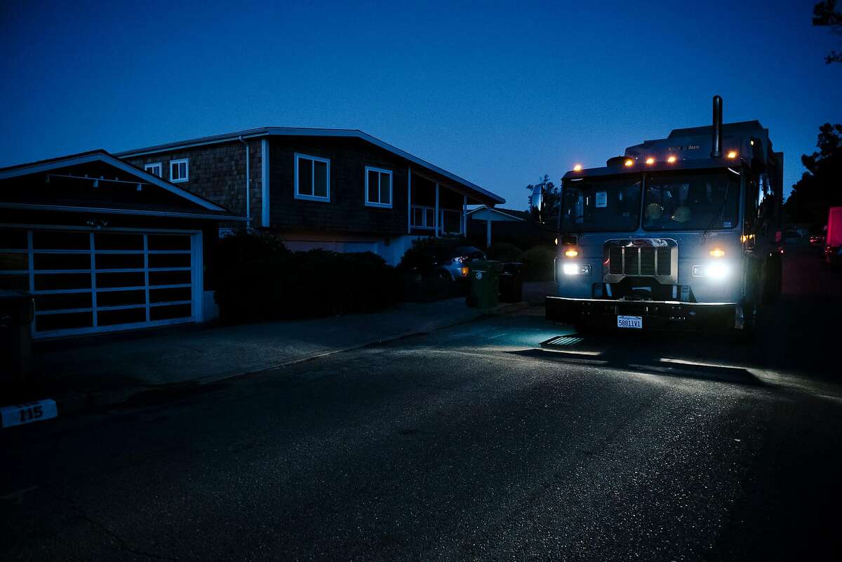 Dennis McMinn of California Waste Solutions said ithat even though he is used to working in the dark of early mornings, it was strange not to have the street lights on as he picks up recycling in a darkened neighborhood off of Skyline Boulevard in Oakland, California, on Friday, Oct. 10, 2019. PG&E planned power outages affected parts of Oakland and Alameda County as the utility fights to stave off wildfires that can be caused by high winds hitting their power lines.