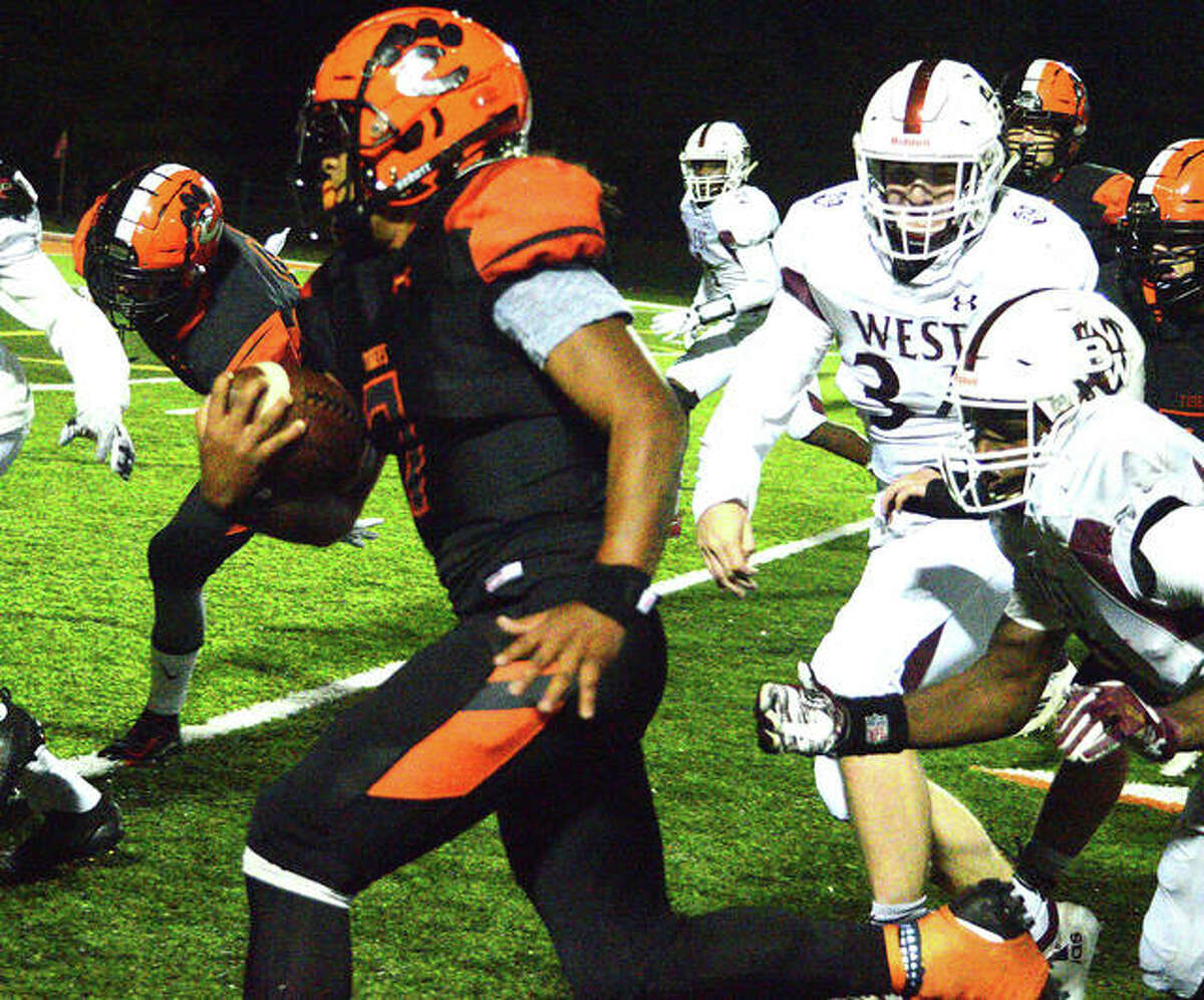 Edwardsville’s Torrence Johnson picks up yardage during the third quarter of Friday’s Homecoming game at the District 7 Sports Complex.