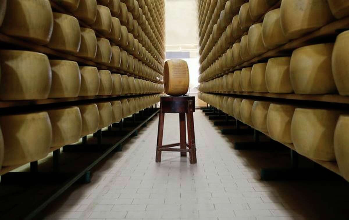 In this photo taken Oct. 8 Parmigiano Reggiano Parmesan cheese wheels are stored in Noceto, near Parma, Italy. (AP Photo/Antonio Calanni)