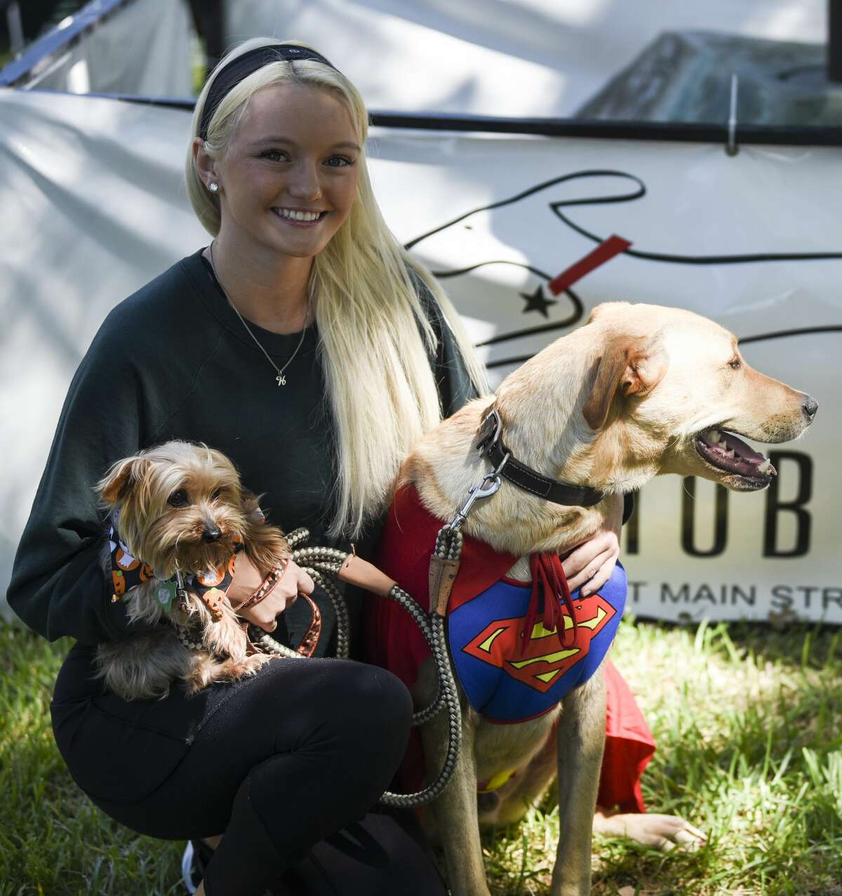 Haleigh Stark with Gunner and Presley at Beaumont's Dogtober Fest near the downtown library Saturday afternoon. Photo taken on Saturday, 10/12/19. Ryan Welch/The Enterprise