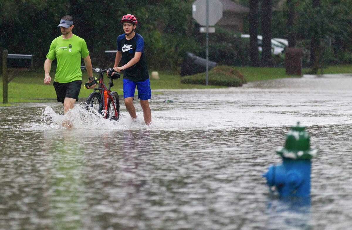 PHOTOS: Imelda by the numbersCharles and Andrew Thompson wade through a flooded street in the Elm Grove subdivision on Sept. 19, 2019, in Kingwood.>>>See where Tropical Storm Imelda dropped the most rain in the photos that follow...