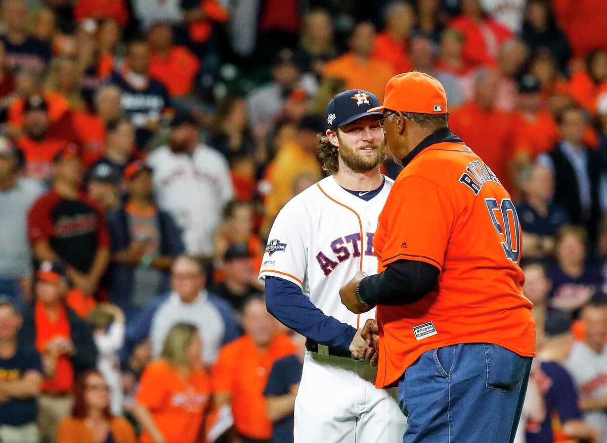 Houston Astros pitcher Gerrit Cole (45) shakes the hand of former Astros pitcher J.R. Richard after Richard threw out the the ceremonial first pitch before Game 1 of the American League Championship Series at Minute Maid Park on Saturday, Oct. 12, 2019, in Houston.
