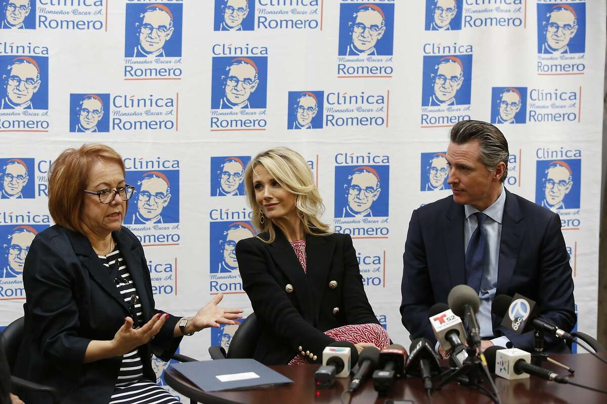 California Sen. Maria Elena Durazo, D-Los Angeles, left, participates with Jennifer Siebel Newsom, and her husband, California Gov. Gavin Newsom at a roundtable discussion with Central American community leaders at the Clinica Monsenor Oscar Romero in Los Angeles, Thursday, March 28, 2019. Newsom said Thursday he will travel to El Salvador in April to discuss the poverty and violence that's causing waves of migrants to seek asylum in the United States. (AP Photo/Damian Dovarganes)
