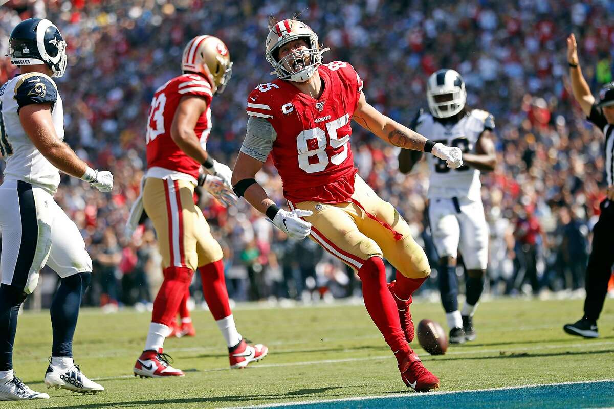 San Francisco 49ers tight end George Kittle (85) stiff-arms Los Angeles  Rams cornerback Marcus …