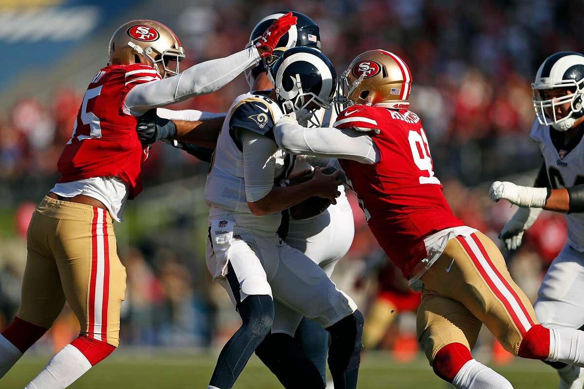 San Francisco 49ers defensive end Nick Bosa (97) and teammate Dee Ford (55)  combine to sack Minnesota Vikings quarterback Kirk Cousins (8) during an  NFL divisional playoff game, Saturday, Jan. 11, 2020