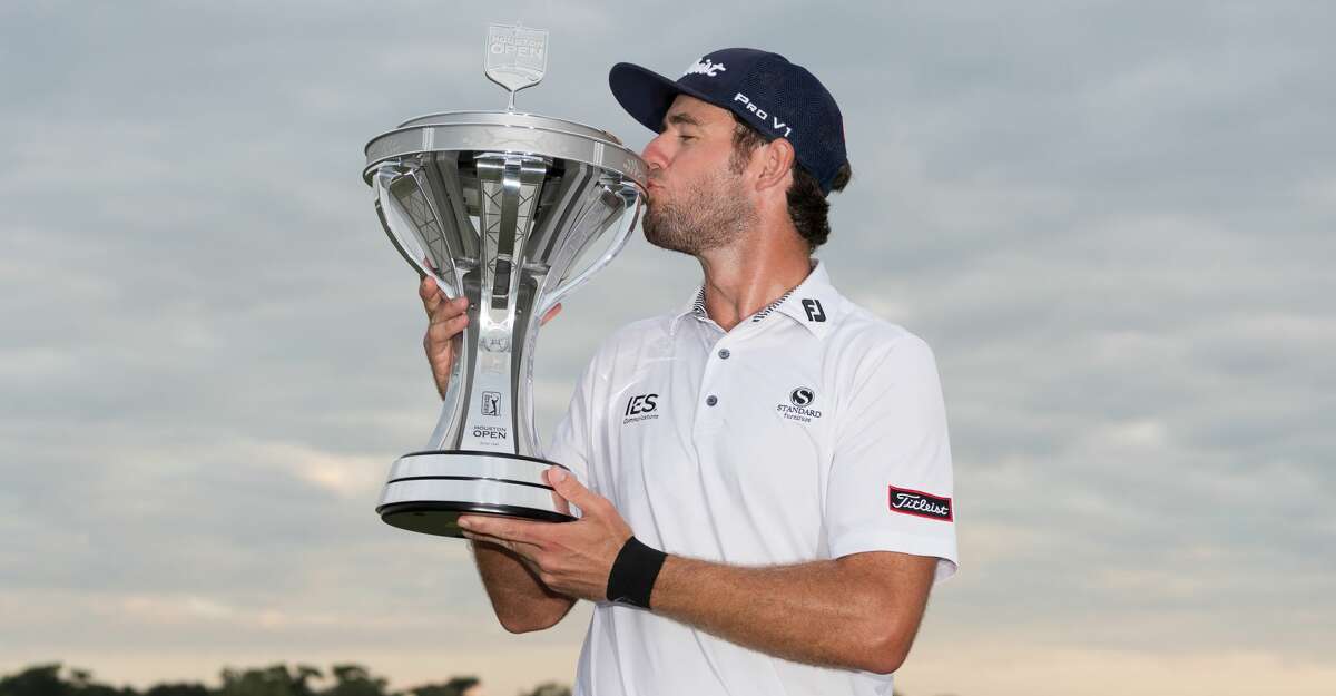 Lanto Griffin kisses the trophy after winning the Houston Open at the Golf Club of Houston in Humble Texas on Sunday, October 13, 2019.
