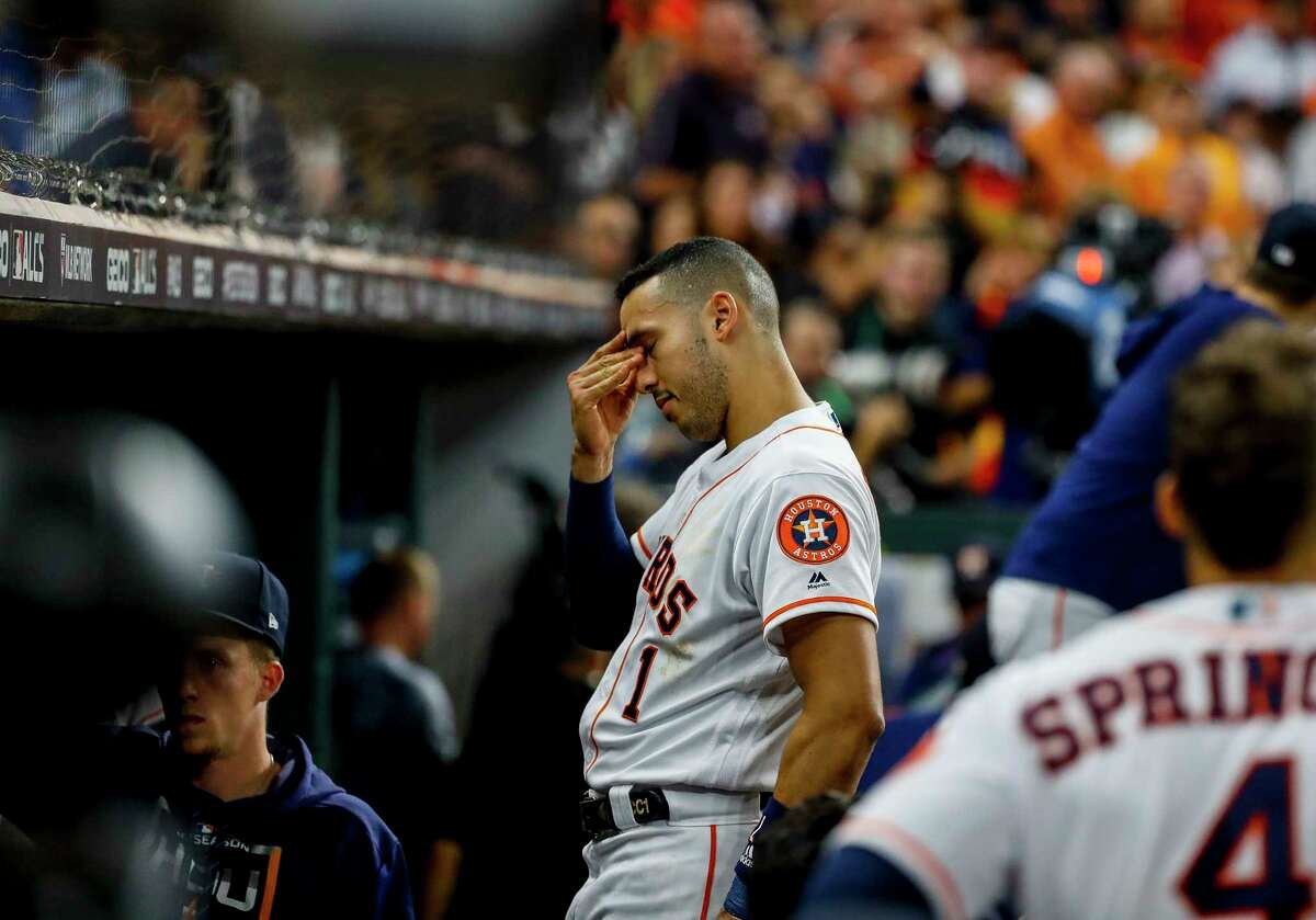 Houston Astros shortstop Carlos Correa (1) reacts as a staff member is attended to after being struck by a foul ball from the bat of Houston Astros left fielder Michael Brantley (23) during the fifth inning of Game 2 of the American League Championship Series at Minute Maid Park on Sunday, Oct. 13, 2019, in Houston.