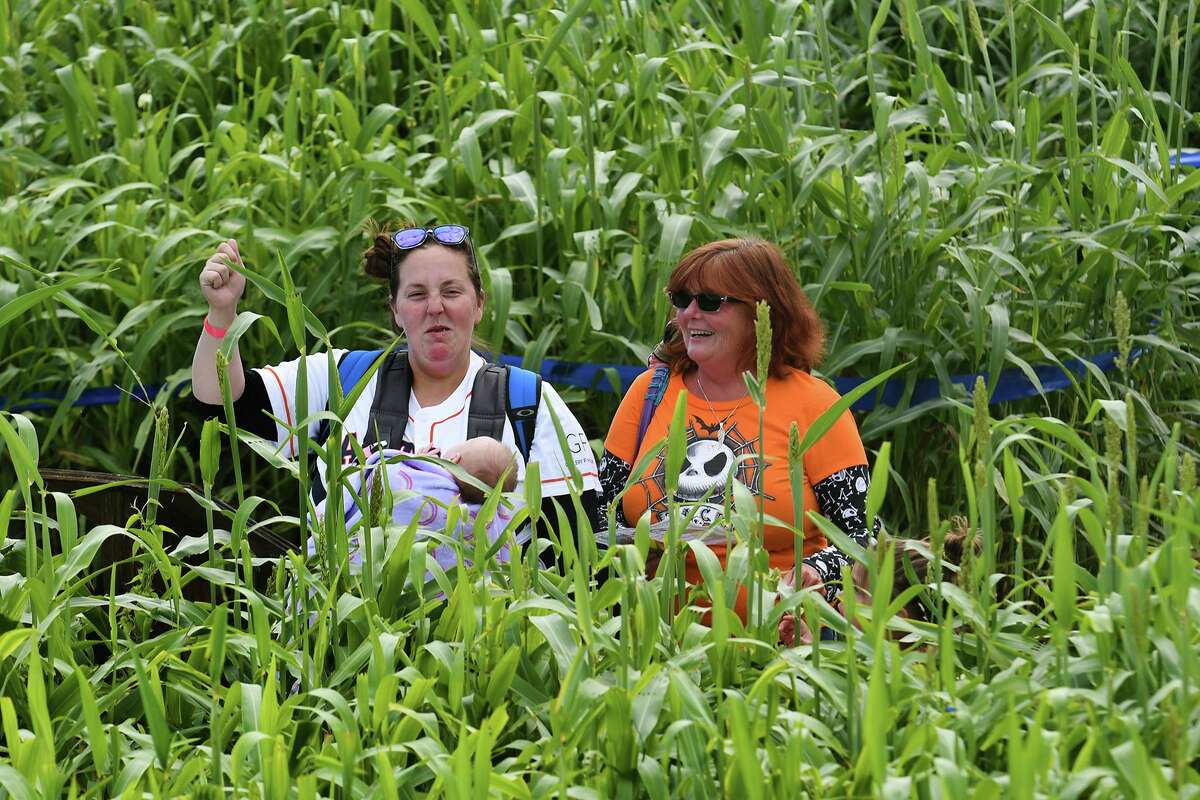 Heather Ottele, left, from Deer Park, carrying her 6 1/2 week old daughter Rileigh, and her mom Betty Howard, also from Deer Park, work their way around the Tomball Corn Maze during "Opening Day" at Salem Lutheran Church in Tomb, all on Oct. 12, 2019.