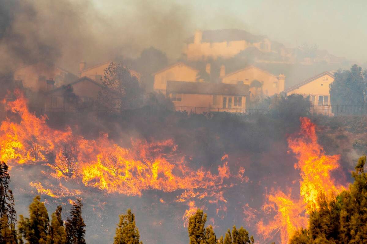 The Saddleridge fire burns in northwest Los Angeles on Friday, Oct. 11, 2019. A fire tore through Southern California overnight into Friday, forcing mandatory evacuations for more than 100,000 people and setting dozens of homes ablaze, just as power was being restored to hundreds of thousands of Northern Californians. (Kyle Grillot for The New York Times)