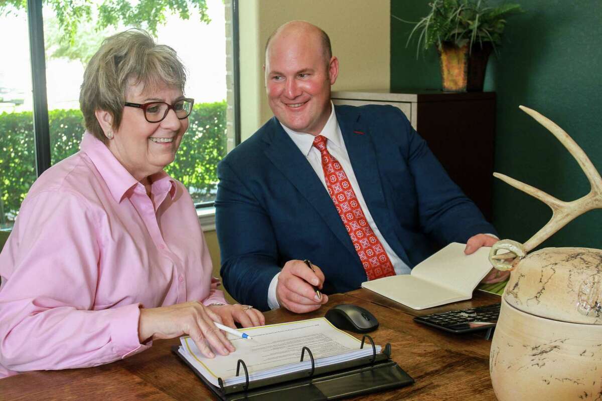 Branch Office Administrator, Paula Bush, and David Coney, Edward Jones Financial Advisor, prepare for a client appointment.