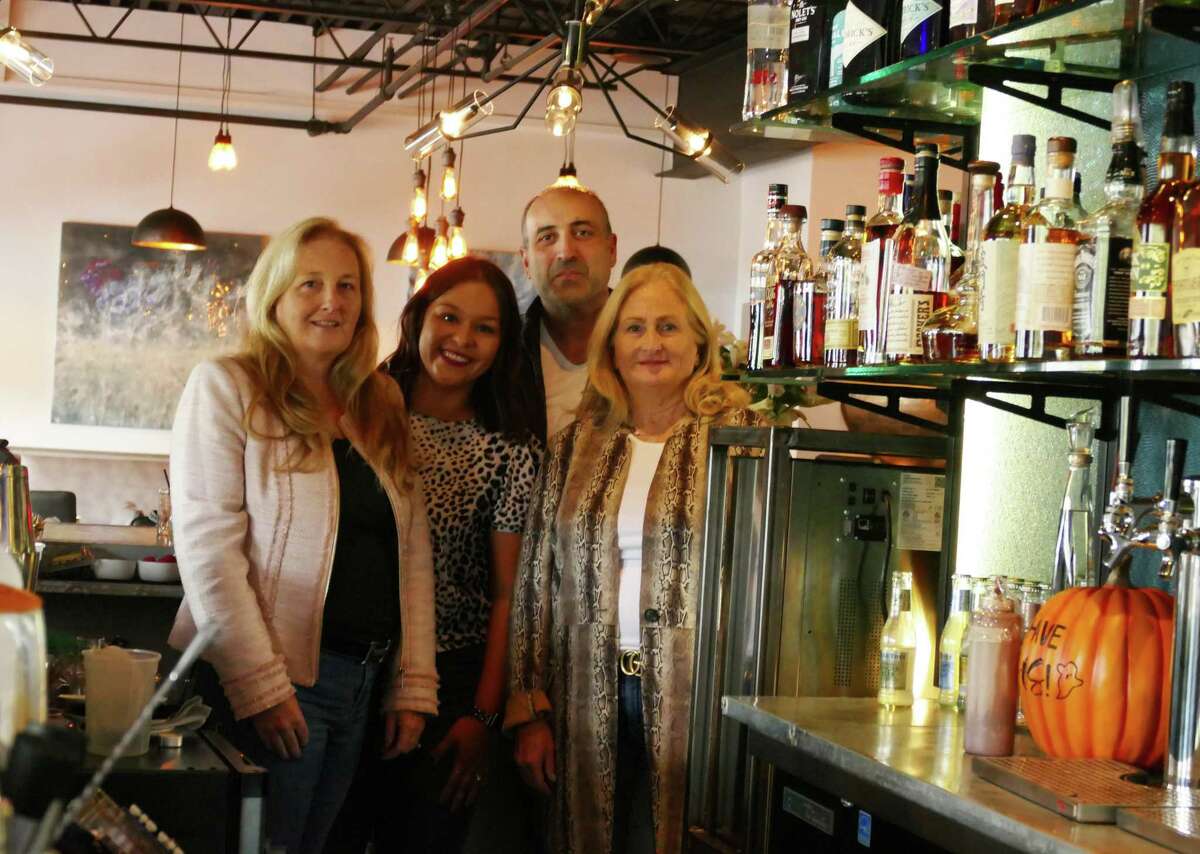 From left to right: Stephanie Heering, Tashi Fleming, Massimo Carro, and Siobhan Santini behind the bar at Posa on Danbury Road. Carro, the restaurant’s owner, has welcomed Heering and Santini to guest bartend for Angel of Ridgefield on Oct. 24.