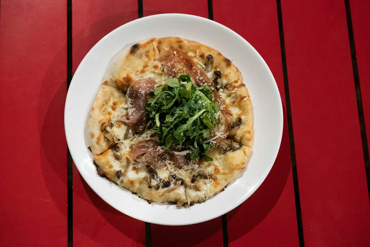 The Bianco Pizza with prosciutto, garden arugula, mushroom, mozzarella, and parmesan at the Grove at the CIA Copia on Sunday, Sept. 29, 2019, in Napa, Calif.