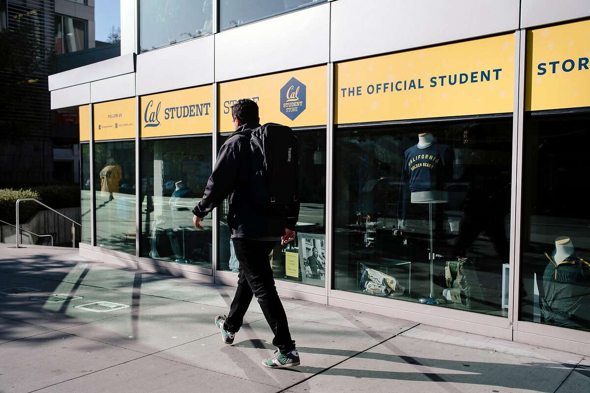 A person walks past the closed Cal Student Store at UC Berkeley in Berkeley, California, on Friday, Oct. 9, 2019. UC Berkeley canceled classes and closed the school on Wednesday in the face of looming planned power shutoff's by PG&E.
