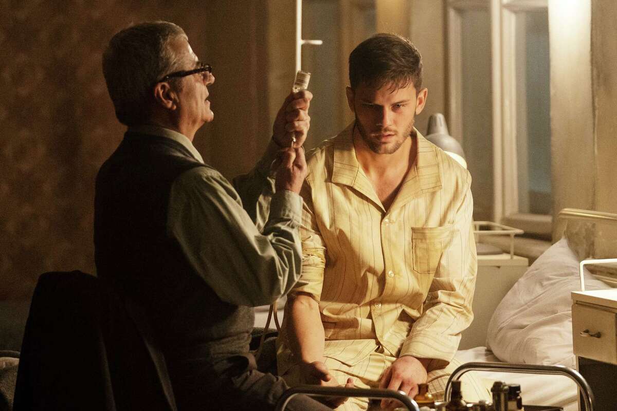 TREADSTONE -- Episode 101 -- Pictured: (l-r) Martin Umbash as Dr. Meisner, Jeremy Irvine as J. Randolph Bentley -- (Photo by: Jonathan Hession/USA Network)