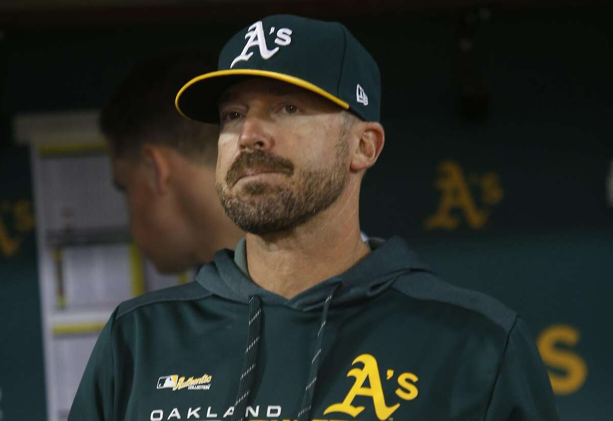 FILE: Bench Coach Ryan Christenson #29 of the Oakland Athletics stands in the dugout during the game against the Texas Rangers at the Oakland-Alameda County Coliseum on April 22, 2019 in Oakland.