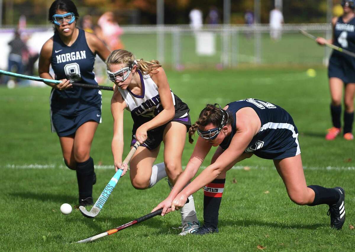 North Branford's Aly Kendrick plays the ball ahead of Morgan defender Delaney Mastriano during their field hockey game in North Branford, Conn. on Monday, October 13, 2019.