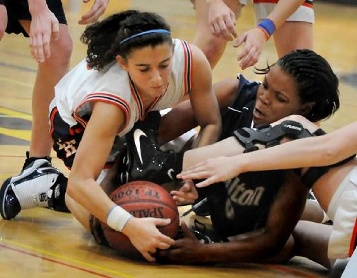 Lyman Hall’s Felicia Ferraro, left, and Lauralton Hall’s Keylantra Langley fight for the ball during the first half of the fifth-ranked Crusaders’ 65-42 win in the championship game of the Hand Holiday Tournament last Wednesday night in Madison. Visit nhregister.com to watch Langley talk about her game, Wednesday night’s win and the Crusaders’ hot start. (Photo by Melanie Stengel/ New Haven Register)