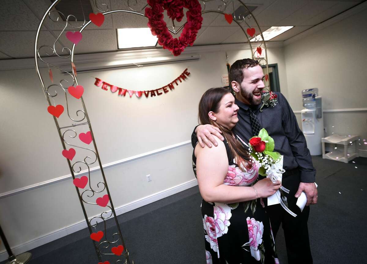 Jessica Vespoli and William Leonardo pose for photographs after being married at the Hamden Government Center during the 20th Annual Valentine's Day Ceremonies on Feb. 14.