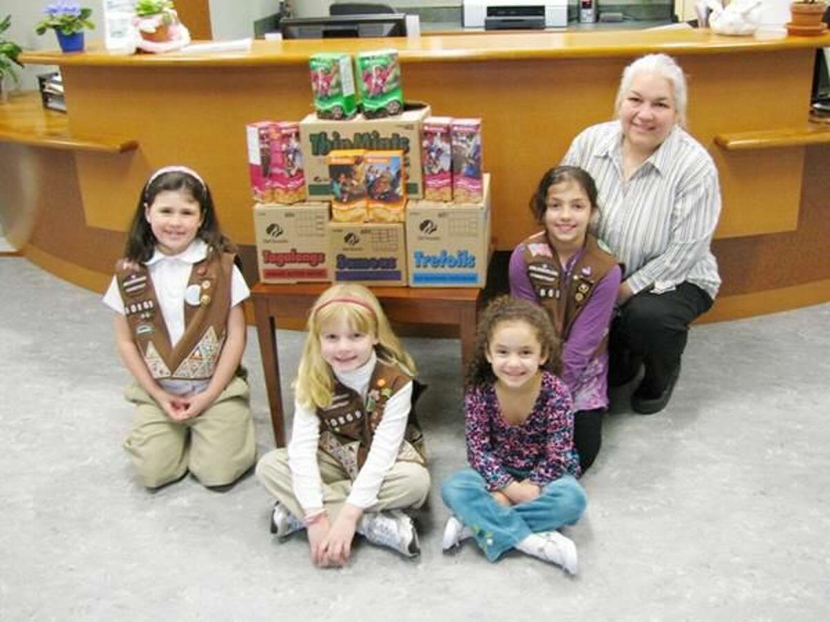 Submitted Photo Pictured from left are Hamden Brownie Troup No. 60869 members Morgan Dubay, Samantha Gilbert, Olivia Sangiovanni and Alexis Sangiovanni with Angela Halloran-Venegas, administrative supervisor at the center.