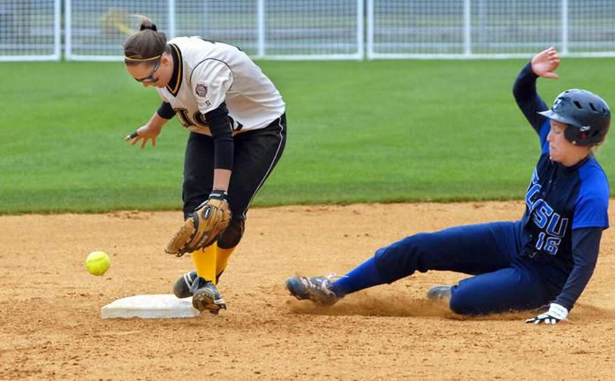 SCSU's Julianne Flood slides safely into second as American International College's Nicole Benoit reaches for the ball. (Photo by Mara Lavitt/ New Haven Register)