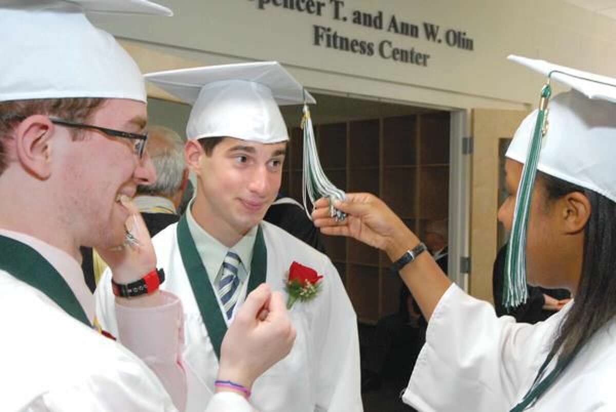 Submitted Photo Evan Hershman of Hamden, center, who will attend Muhlenberg College in the fall, prepares for Hamden Hall's graduation ceremonies June 11.