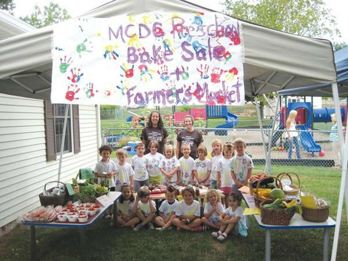 Submitted Photo Students in the pre-K class at the Masonic Child Development Center, along with teachers Christine Schardan (left) and Nicole Browell, display the fruits of their labor at the Center’s Eighth Annual Farmers’ Market.