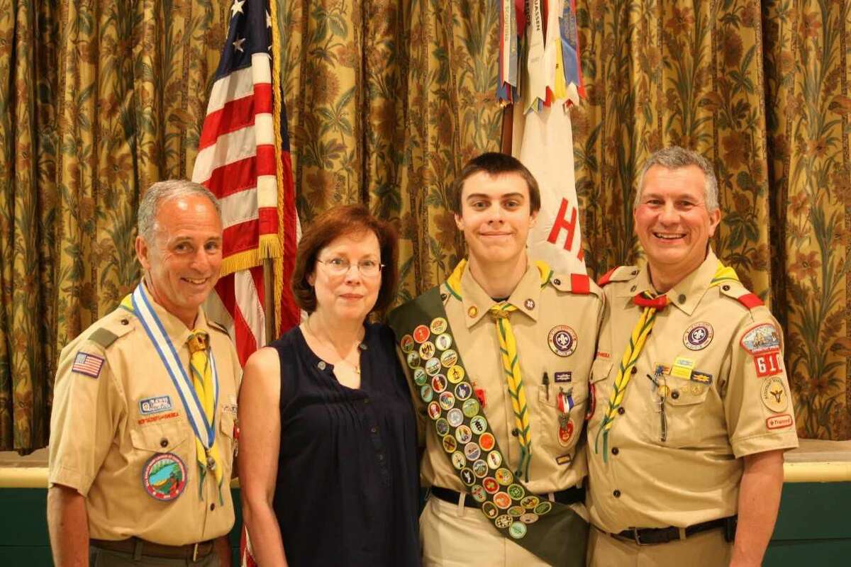 Eagle Scout Gordon Gaidish with parents Lori and Tom Gaidish and Scoutmaster Bill Earley.