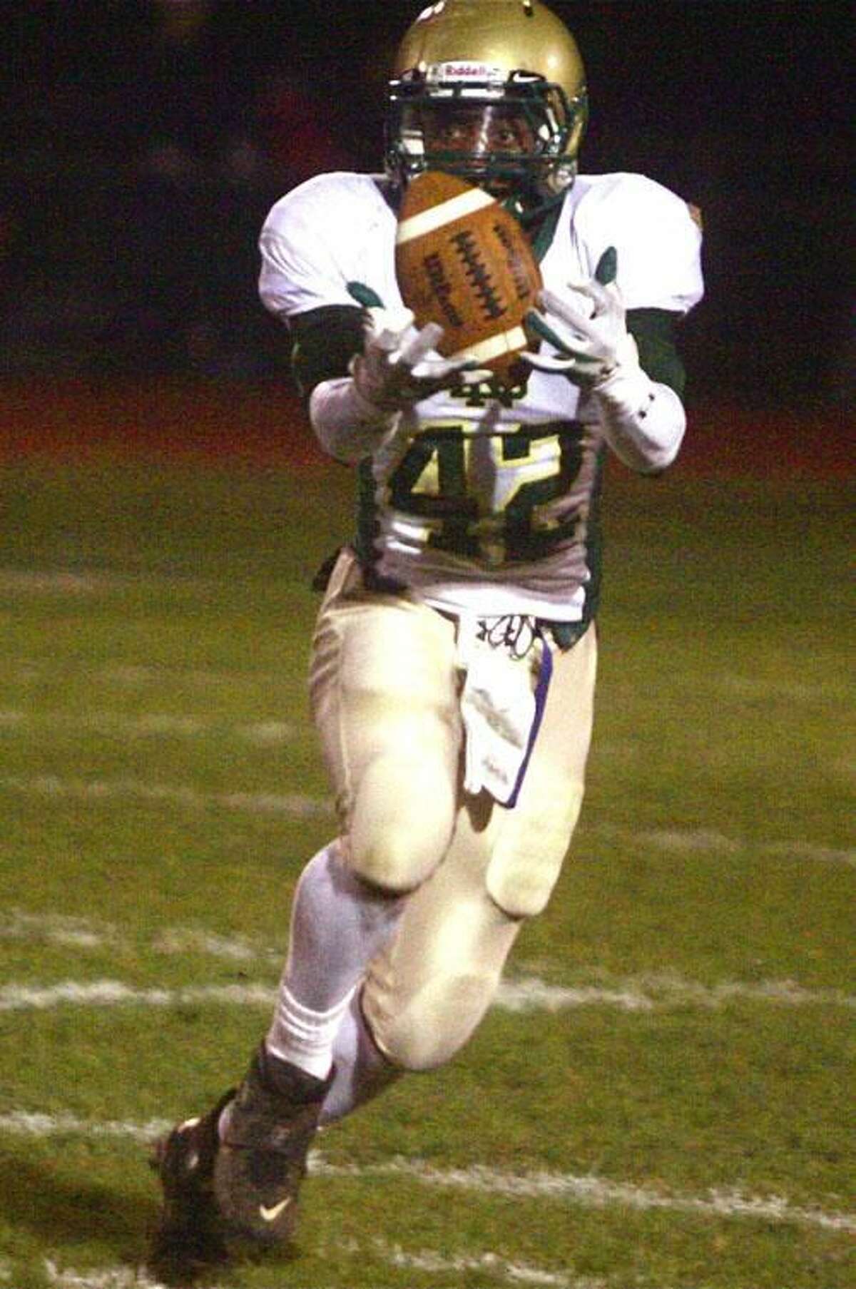 Photo by Russ McCreven Notre Dame's Tirrell Young-Williams grabs hold of the ball against North Haven.