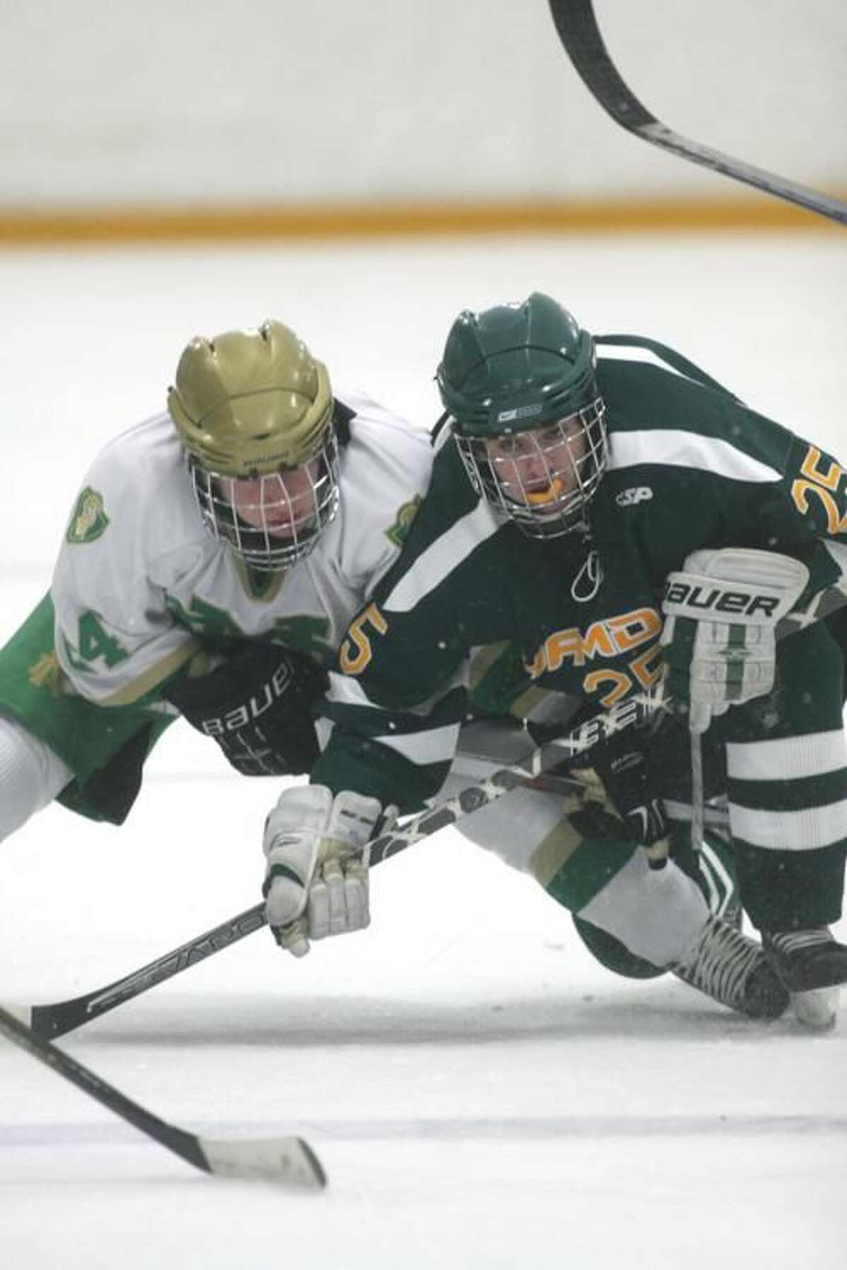 Photo by Russ McCreven Hamden's Vito Puopolo tangles with Notre Dame's Kevin DuBrow in the Green Dragons’ 4-1 victory.