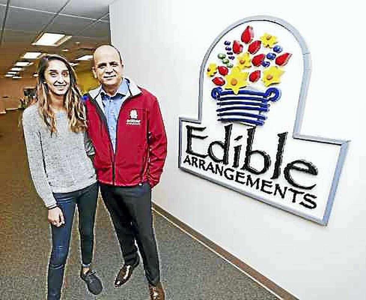 Arnold Gold — New Haven Register.  Somia Farid, left, special projects manager for Edible Arrangements, is photographed with her father, Tariq Farid, founder and CEO, at the company headquarters in Wallingford.