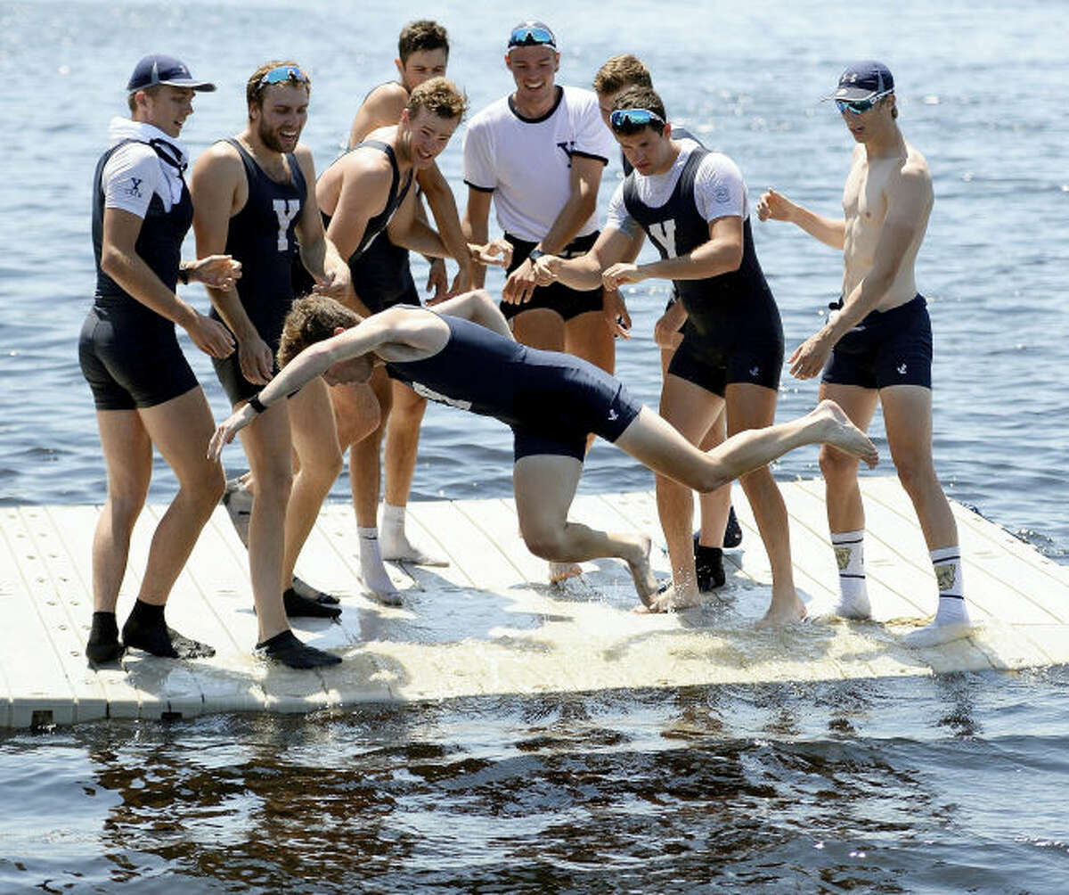 Yale rowers toss their coxswain, Grant Louis, into the Thames.