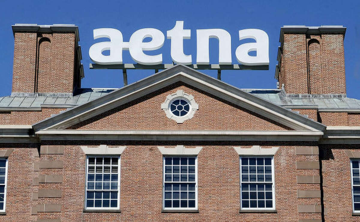 In this Tuesday, Aug. 19, 2014, file photo, a sign for Aetna Inc., sits atop a building at the company headquarters in in Hartford, Conn. Health insurer Aetna Inc. has made a deal to buy competitor Humana Inc. in a $37 billion deal the companies say would create the second-largest managed care company, it was announced Friday, July 3, 2014.