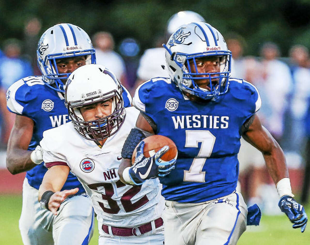 (John Vanacore/For Hearst Connecticut Media) West Haven's Kyle Godfrey(7) outruns North Haven's Devan Brockamer(32) for a big gain during the Blue Devil's 33-27 Friday night.West Haven’s Kyle Godfrey (7) outruns North Haven’s Devan Brockamer for a big gain on Friday.