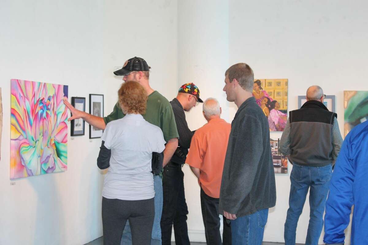 Attendees view a painting at Hartford Artspace.