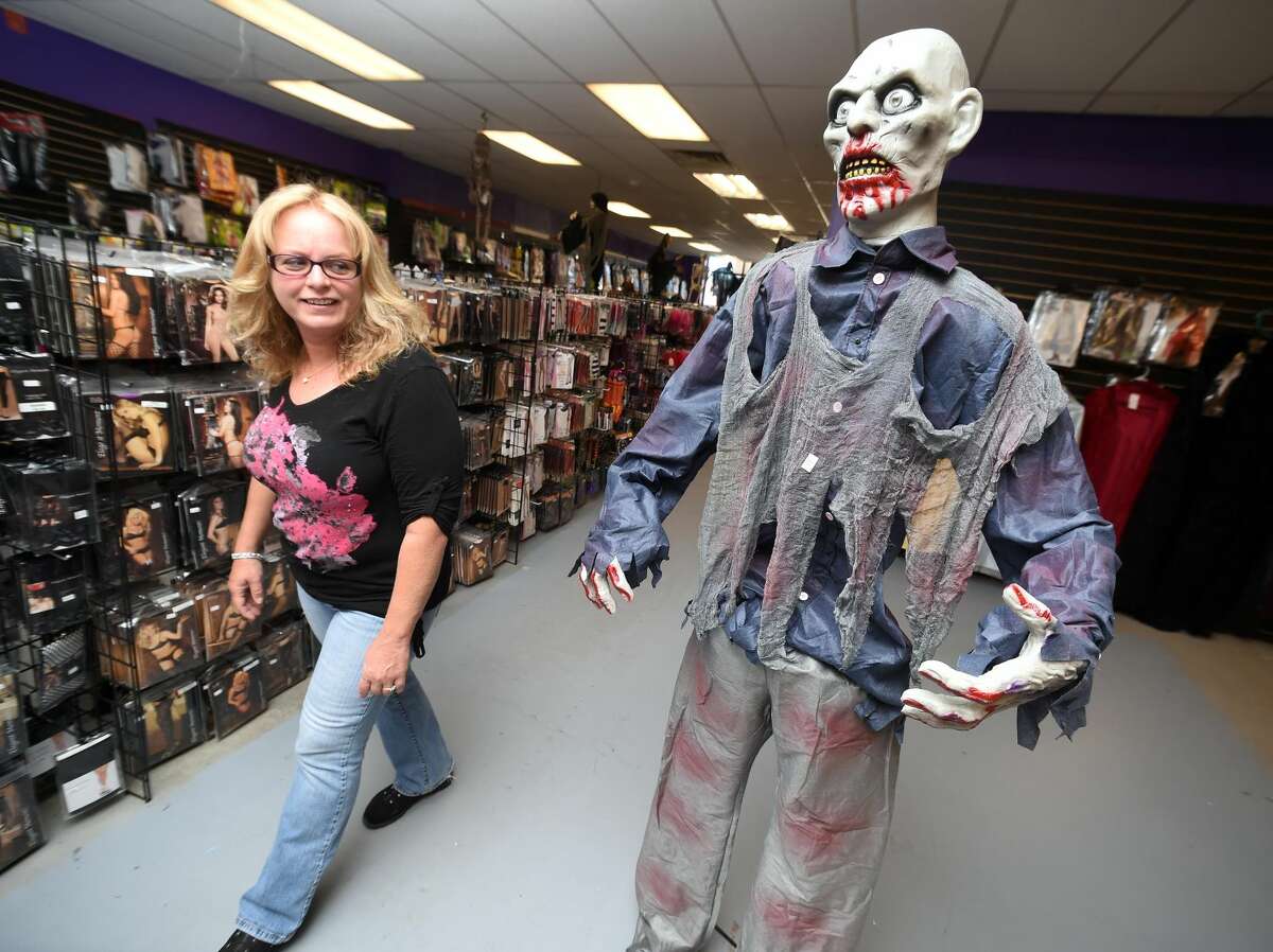 Patricia Kassas of Derby walks past a zombie in the Spooky Town Halloween Superstore in Orange on October 1, 2017. Arnold Gold / Hearst Connecticut Media